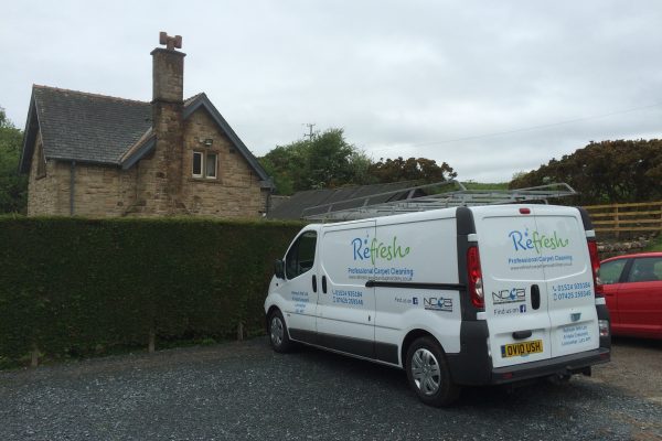 The Refresh carpet and upholstery cleaning van parked outside a house. Looking very professional.