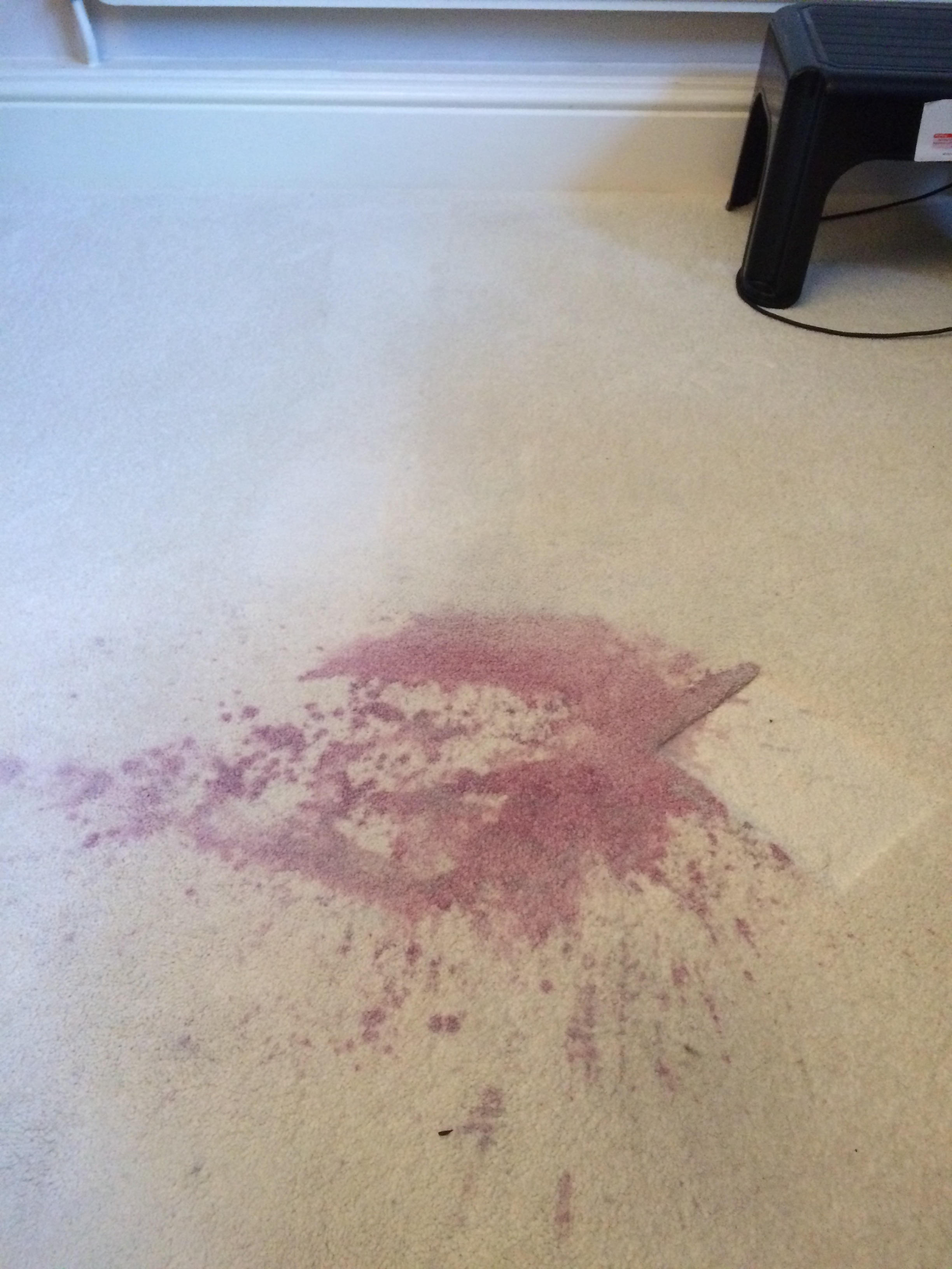 Large red wine stain splash on a cream carpet in Morecambe.